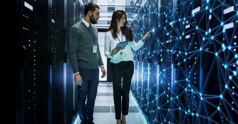 Two people walk in a data center
